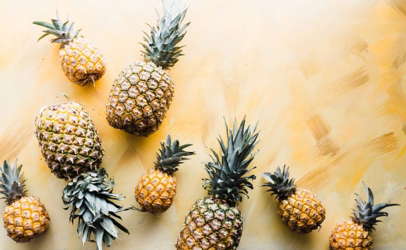 Pineapples laid out on a wooden table