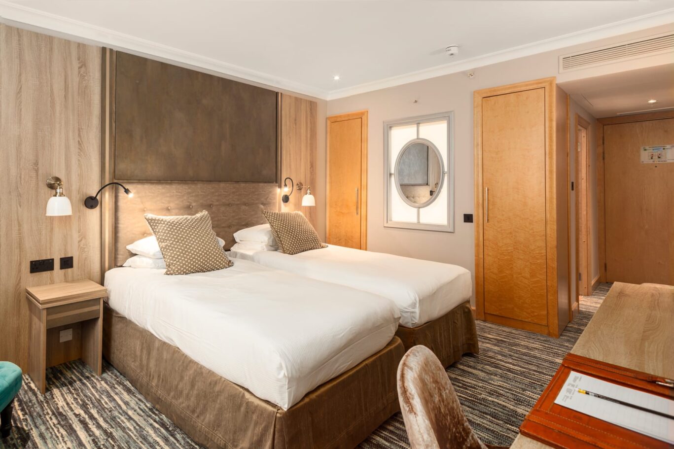 Twin room with two single beds and a grey headboard.