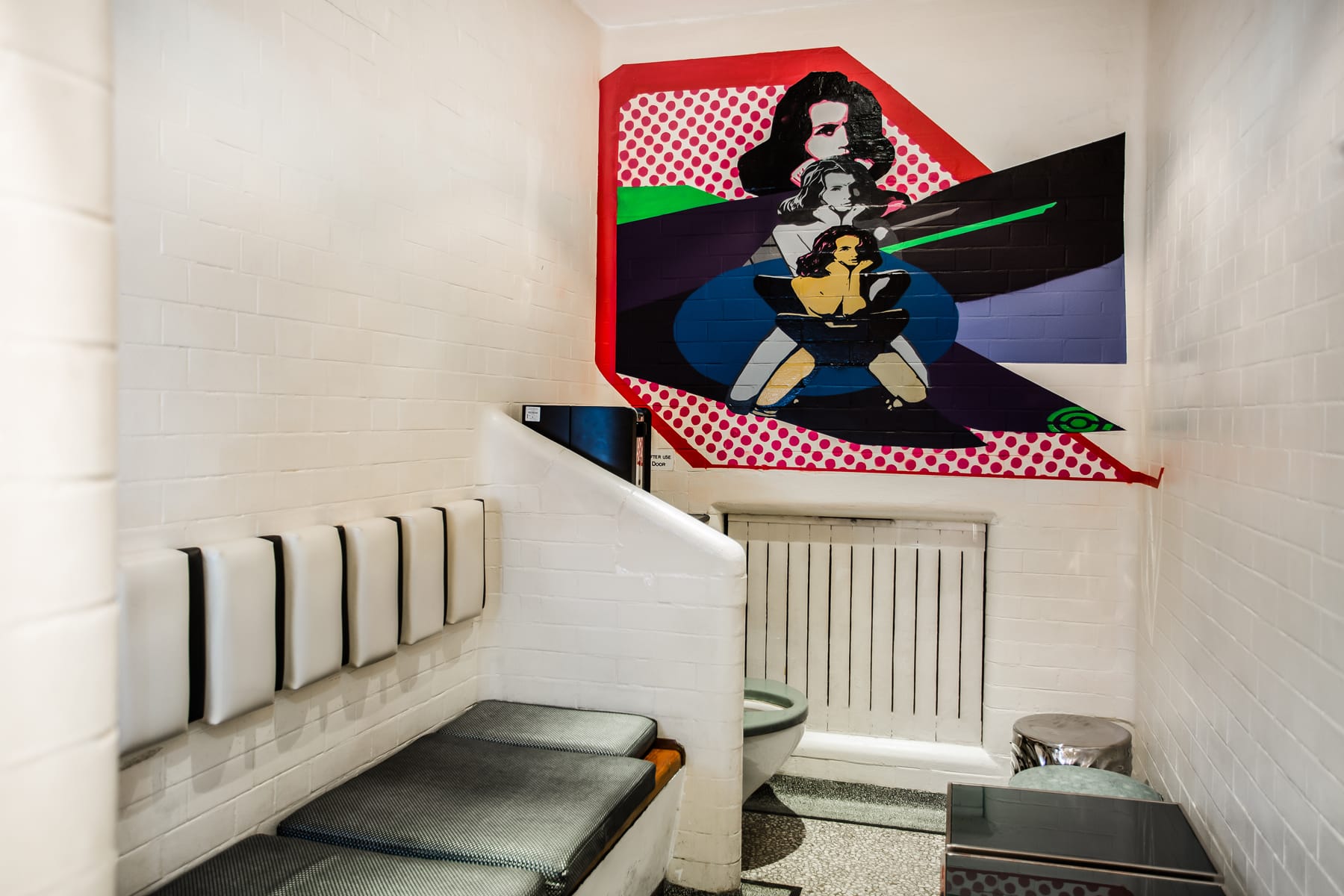 Bathroom with comic art graphic on the wall.