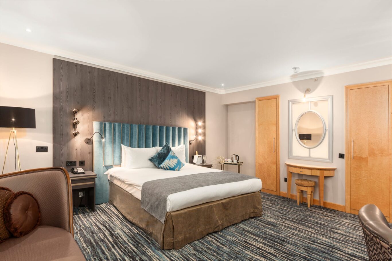 Large double bed suite with velvet blue headboard.
