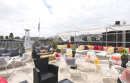 Colourful roof terrace with patio heaters and sofas