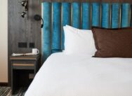 View of the bed and side table in a suite room.